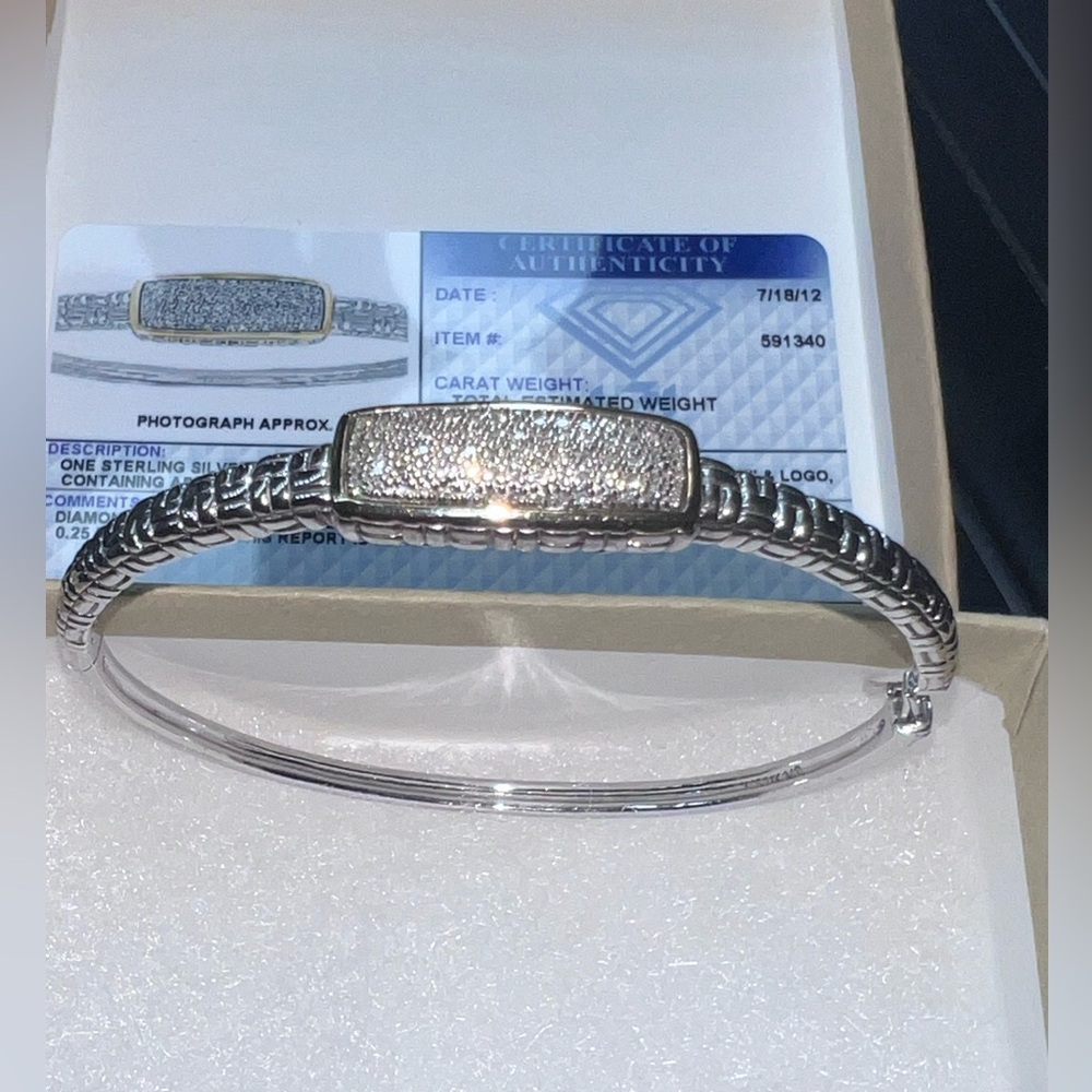STERLING SILVER BRACELET WITH 14 KARAT GOLD TRIM.